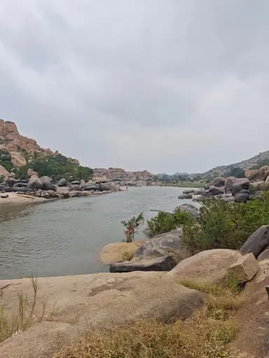 A calm river winding between large granite boulders